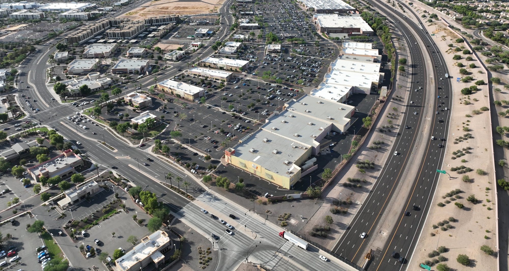 Aerial view of SanTan Village Marketplace along Loop 202, with the mountains beyond